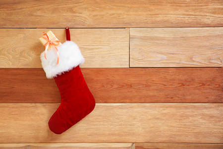 Christmas sock with gift hanging wooden wallの写真素材
