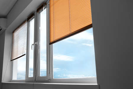 Modern blinds hanging on window