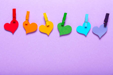 Many hearts with pegs on color background. LGBT conceptの写真素材