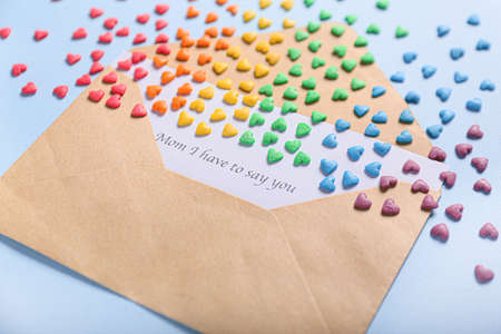 Envelope with letter and hearts on color background. LGBT concept