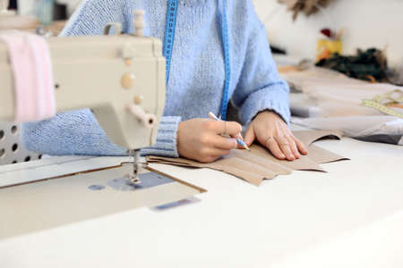 Female tailor working in modern atelier