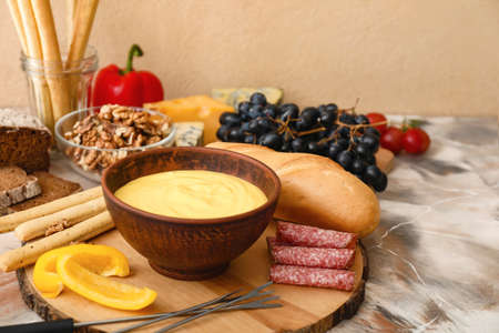 Cheese fondue with snacks on table