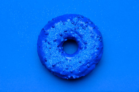 Tasty blue donut on color backgroundの写真素材
