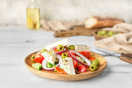 Plate of tasty Greek salad on tableの写真素材
