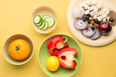 Ingredients for tasty Greek salad on color backgroundの写真素材