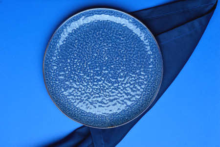 Empty plate on blue backgroundの写真素材