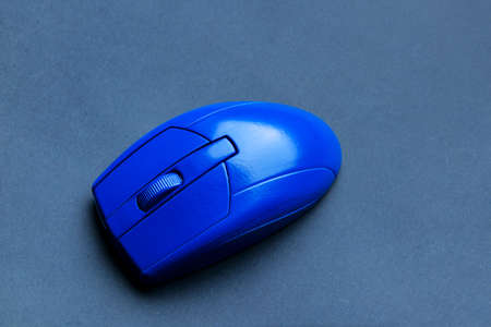 Blue PC mouse on gray backgroundの写真素材