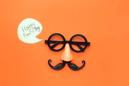 Party decor on color background. April Fool's Day prank