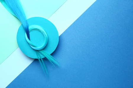 Blue hair strand on color background