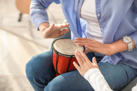 Private music teacher giving lessons to little girl at homeの写真素材