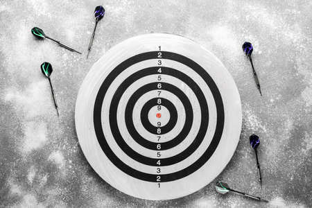 Darts with dartboard on gray backgroundの写真素材