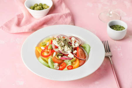 Plate with fresh Greek salad on tableの写真素材