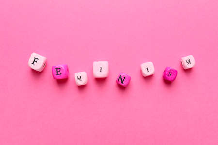 Word FEMINISM with cubes on color backgroundの写真素材