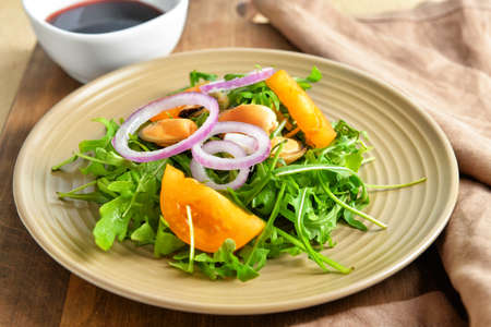 Plate with tasty salad on tableの写真素材