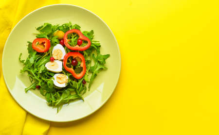 Plate with tasty salad on color backgroundの写真素材
