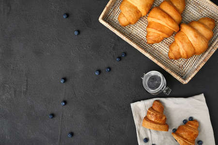 Tasty sweet croissants with jam on dark backgroundの写真素材