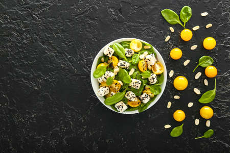 Bowl with tasty salad on dark backgroundの写真素材