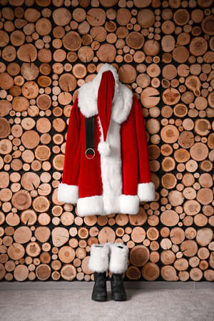 Santa Claus costume hanging on wooden wallの写真素材