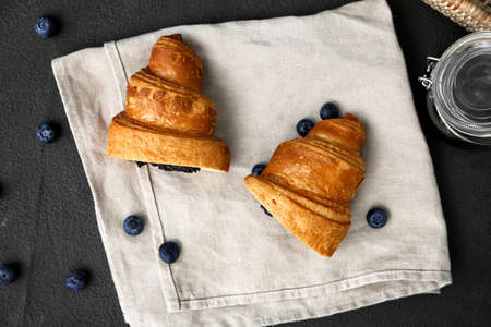 Tasty sweet croissant with jam on dark backgroundの写真素材