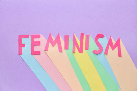 Paper word FEMINISM on color backgroundの写真素材