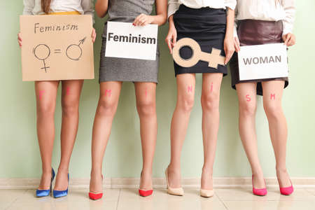 Young women near color wall. Concept of feminismの写真素材