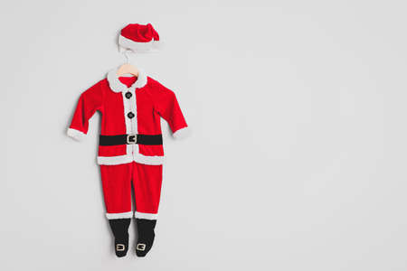 Santa Claus costume hanging on white wallの写真素材