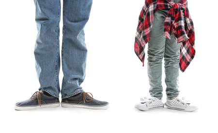 Legs of father and his little daughter on white backgroundの写真素材