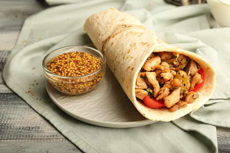 Plate with tasty doner kebab on tableの写真素材