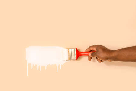 Hand of African-American worker painting wallの写真素材