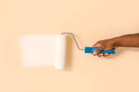 Hand of African-American worker painting wallの写真素材