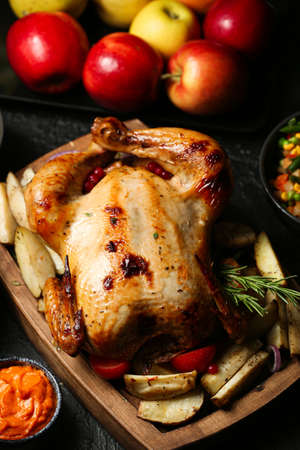 Tasty baked turkey and other dishes for Thanksgiving day on tableの写真素材