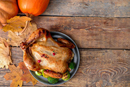 Tasty baked turkey for Thanksgiving day on tableの写真素材