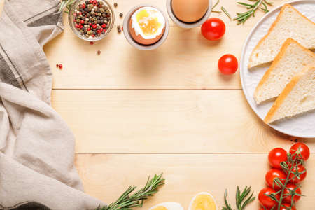 Frame made of cooked eggs with bread and spices on wooden backgroundの写真素材