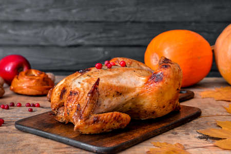 Tasty baked turkey for Thanksgiving day on tableの写真素材