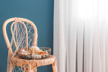 Beautiful marine decor on chair in roomの写真素材