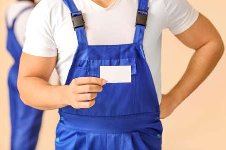 Male painter with business card in room, closeupの写真素材