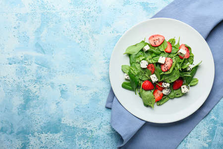 Plate with tasty salad on color backgroundの写真素材