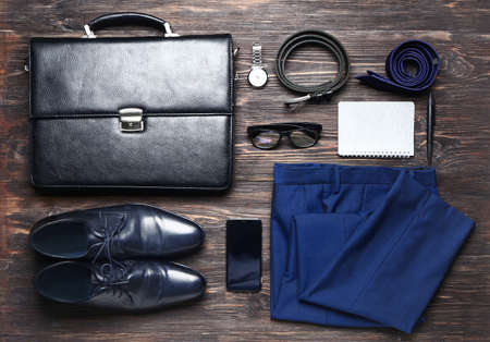 Stylish male clothes with accessories and mobile phone on wooden backgroundの写真素材