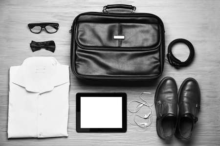 Stylish male clothes with accessories and tablet computer on wooden backgroundの写真素材