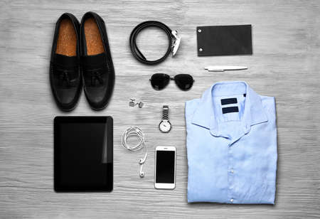 Stylish male clothes with accessories and devices on wooden backgroundの写真素材