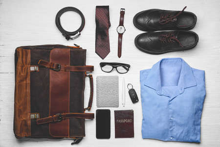 Stylish male clothes with accessories, passport and mobile phone on white wooden backgroundの写真素材