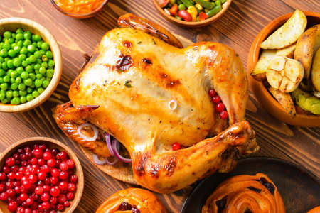 Tasty baked turkey and different food for Thanksgiving day on tableの写真素材