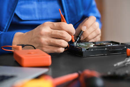 Electronic technician repairing computer in service center, closeupの写真素材