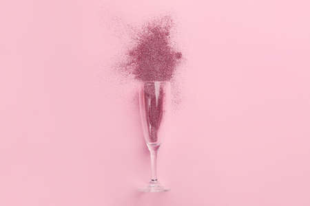 Glass with glitters on pink backgroundの写真素材