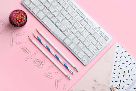 Composition with PC keyboard and stationery on pink backgroundの写真素材