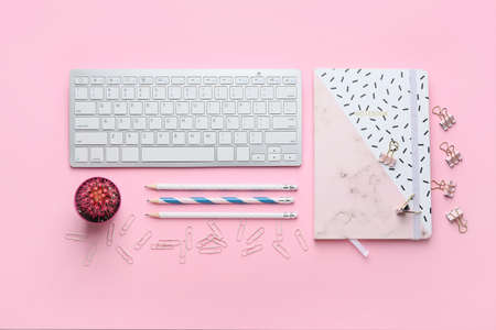 Composition with PC keyboard and stationery on pink backgroundの写真素材