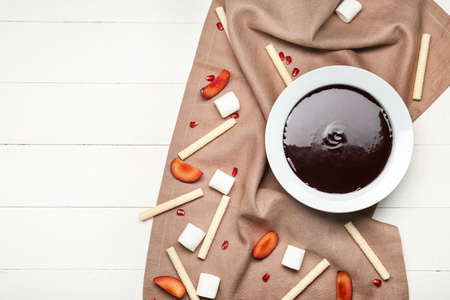Bowl with tasty chocolate fondue on tableの写真素材