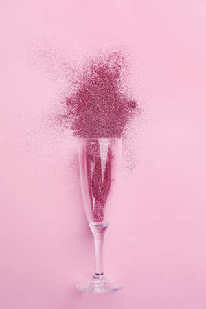 Glass with glitters on pink backgroundの写真素材