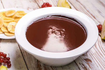 Bowl with tasty chocolate fondue on tableの写真素材