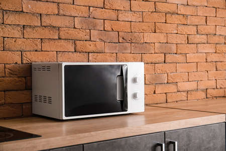 Modern microwave oven in kitchenの写真素材
